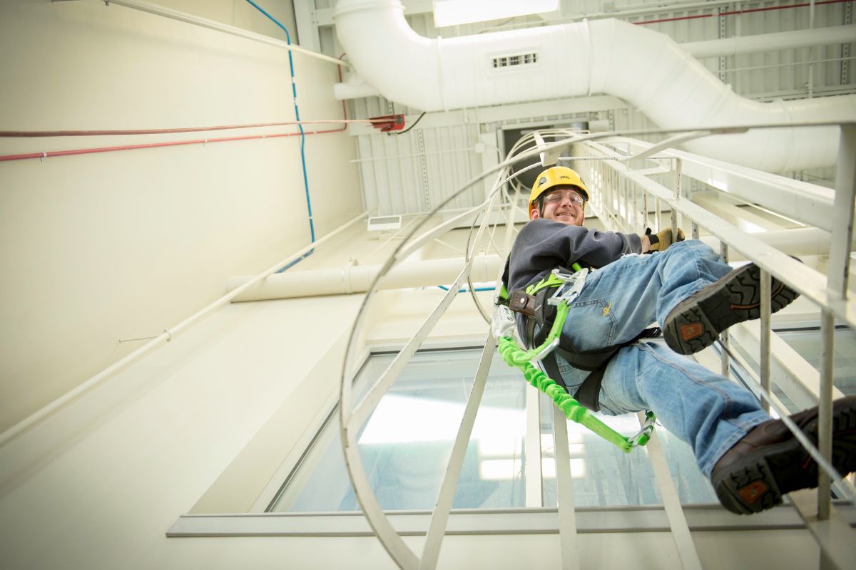 Wind technician descending turbine shaft ladder. 